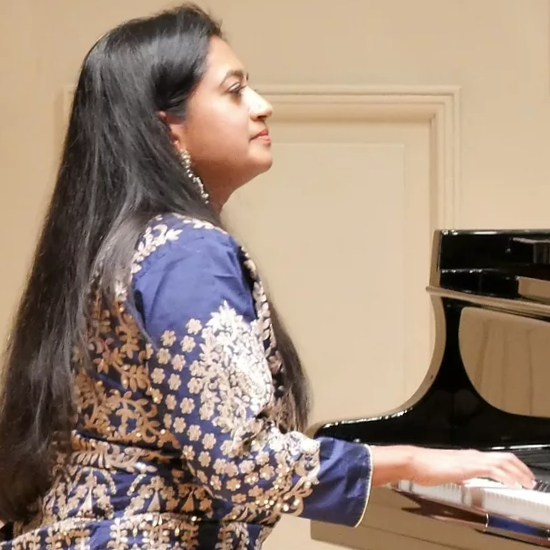 Portrait of Charu Suri, winner of InterContinental Music Awards 2022, posing for their award