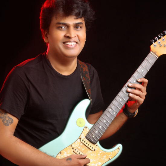 Portrait of Santhosh Chandran, winner of InterContinental Music Awards 2022, posing for their award