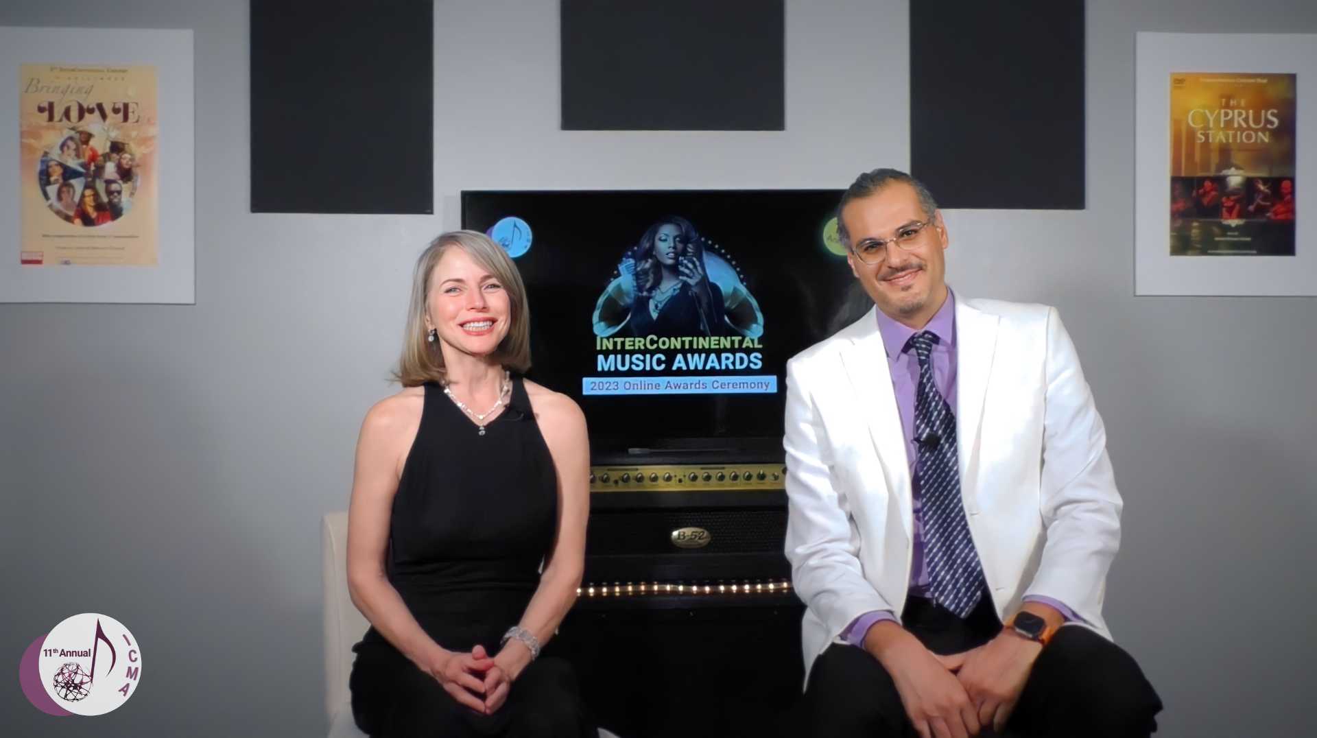 Shahed Mohseni and Karen Lorre presenting the 2023 InterContinental Music Awards online ceremony. Both are dressed in formal attire, in ICMAs office.