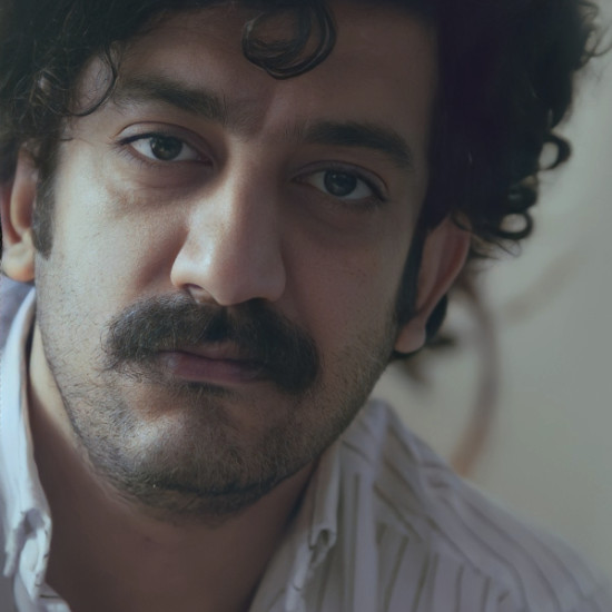 Portrait of Mehdi Rajabian, winner of InterContinental Music Awards 2023, posing for their award