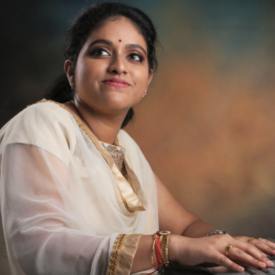 Portrait of S. J. Jananiy, winner of InterContinental Music Awards 2023, posing for their award
